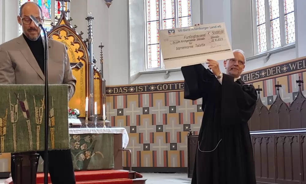 Pfarrer Thomas Eisner hat den Scheck über 50.000 Euro vom Vereinsvorsitzenden des Kirchbauvereins, Dr. Jörg Milde (l.), entgegengenommen